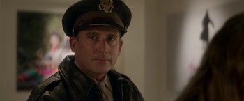 Movie still from “Welcome to Marwen” (2018), directed by Robert Zemeckis – A person wearing a uniform; Close Up shot, Over the shoulder angle