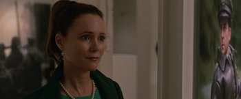 Movie still from “Welcome to Marwen” (2018), directed by Robert Zemeckis – A person wearing a green shirt; Close Up shot, Over the shoulder angle