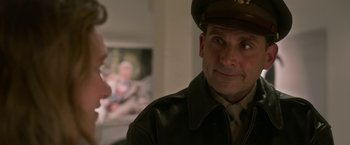 Movie still from “Welcome to Marwen” (2018), directed by Robert Zemeckis – A person wearing a uniform; Medium shot, Over the shoulder angle