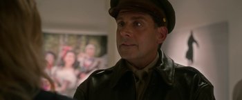 Movie still from “Welcome to Marwen” (2018), directed by Robert Zemeckis – A person wearing a uniform; Close Up shot, Over the shoulder angle