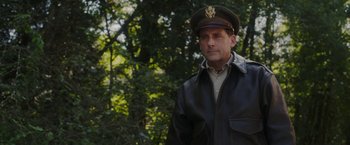Movie still from “Welcome to Marwen” (2018), directed by Robert Zemeckis – A man wearing a leather jacket and a hat; Medium shot, Low angle