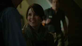 Movie still from “Whiskey Tango Foxtrot” (2016), directed by Glenn Ficarra – A woman smiling while standing next to a man; Close Up shot, Over the shoulder angle