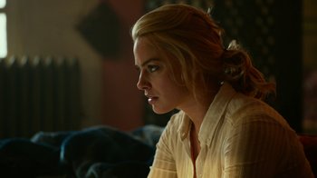 Movie still from “Whiskey Tango Foxtrot” (2016), directed by Glenn Ficarra – A woman sitting in a chair looking to her left; Close Up shot, Over the shoulder angle