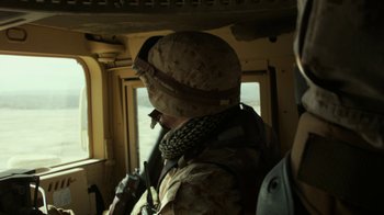 Movie still from “Whiskey Tango Foxtrot” (2016), directed by Glenn Ficarra – A man in a military uniform is looking out a window; Medium shot, Over the shoulder angle