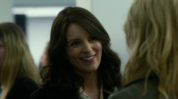 Movie still from “Whiskey Tango Foxtrot” (2016), directed by Glenn Ficarra – A person smiling at the camera; Close Up shot, Over the shoulder angle