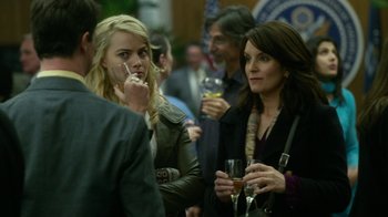 Movie still from “Whiskey Tango Foxtrot” (2016), directed by Glenn Ficarra – A group of people standing next to each other at an event; Close Up shot, Over the shoulder angle