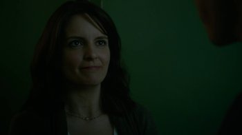 Movie still from “Whiskey Tango Foxtrot” (2016), directed by Glenn Ficarra – A person with long dark hair; Close Up shot, Over the shoulder angle