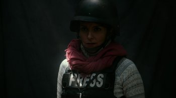 Movie still from “Whiskey Tango Foxtrot” (2016), directed by Glenn Ficarra – A woman wearing a helmet and a press vest; Close Up shot, Low angle