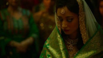 Movie still from “Whiskey Tango Foxtrot” (2016), directed by Glenn Ficarra – A woman in a green and gold sari; Close Up shot, Over the shoulder angle