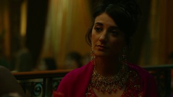 Movie still from “Whiskey Tango Foxtrot” (2016), directed by Glenn Ficarra – A woman in a red dress and a red necklace; Close Up shot, Over the shoulder angle