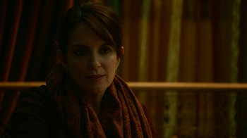 Movie still from “Whiskey Tango Foxtrot” (2016), directed by Glenn Ficarra – A woman wearing a brown scarf looking at the camera; Close Up shot, Over the shoulder angle