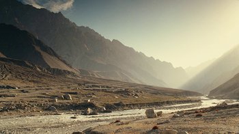 Movie still from “Whiskey Tango Foxtrot” (2016), directed by Glenn Ficarra – A view of a mountain range with a river running through it; Extreme Wide shot, High angle