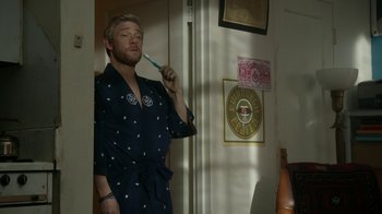 Movie still from “Whiskey Tango Foxtrot” (2016), directed by Glenn Ficarra – A man brushing his teeth while standing in a room; Medium shot, Over the shoulder angle