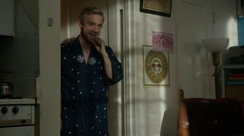 Movie still from “Whiskey Tango Foxtrot” (2016), directed by Glenn Ficarra – A man standing in front of a mirror while talking on a phone; Medium shot, Over the shoulder angle