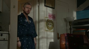 Movie still from “Whiskey Tango Foxtrot” (2016), directed by Glenn Ficarra – A man standing in front of a door in a room; Medium shot, Over the shoulder angle