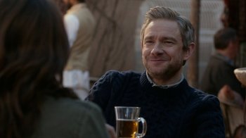 Movie still from “Whiskey Tango Foxtrot” (2016), directed by Glenn Ficarra – A man sitting at a table with a glass of beer; Close Up shot, Over the shoulder angle