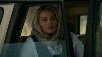 Movie still from “Whiskey Tango Foxtrot” (2016), directed by Glenn Ficarra – A woman in a car looking out of the window; Close Up shot, Over the shoulder angle