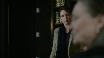 Movie still from “Whiskey Tango Foxtrot” (2016), directed by Glenn Ficarra – A woman standing in front of a mirror in a room; Close Up shot, Over the shoulder angle