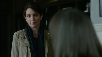 Movie still from “Whiskey Tango Foxtrot” (2016), directed by Glenn Ficarra – A woman is looking at the camera in the mirror; Close Up shot, Over the shoulder angle