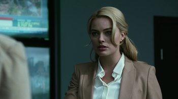 Movie still from “Whiskey Tango Foxtrot” (2016), directed by Glenn Ficarra – A woman with blonde hair wearing a white shirt and jacket; Close Up shot, Over the shoulder angle