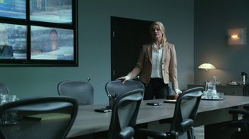 Movie still from “Whiskey Tango Foxtrot” (2016), directed by Glenn Ficarra – A woman standing in front of a conference room table; Medium shot, Over the shoulder angle