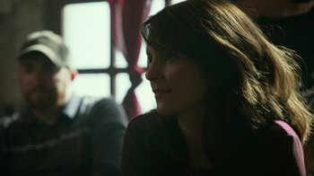 Movie still from “Whiskey Tango Foxtrot” (2016), directed by Glenn Ficarra – A woman sitting in front of a window looking to her left; Close Up shot, Over the shoulder angle