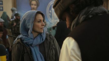 Movie still from “Whiskey Tango Foxtrot” (2016), directed by Glenn Ficarra – A woman wearing a blue scarf and a blue jacket; Close Up shot, Over the shoulder angle