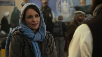 Movie still from “Whiskey Tango Foxtrot” (2016), directed by Glenn Ficarra – A woman wearing a blue scarf and a jacket; Close Up shot, Over the shoulder angle