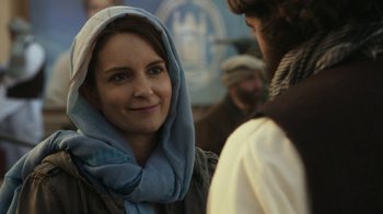 Movie still from “Whiskey Tango Foxtrot” (2016), directed by Glenn Ficarra – A woman wearing a blue scarf and a blue headscarf; Close Up shot, Over the shoulder angle