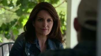 Movie still from “Whiskey Tango Foxtrot” (2016), directed by Glenn Ficarra – A person wearing a jean jacket; Close Up shot, Over the shoulder angle