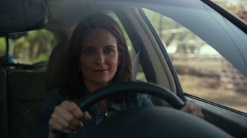 Movie still from “Whiskey Tango Foxtrot” (2016), directed by Glenn Ficarra – A woman sitting in the drivers seat of a car; Close Up shot, Over the shoulder angle