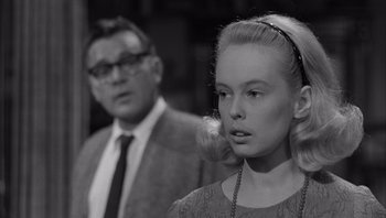 Movie still from “Who's Afraid of Virginia Woolf?” (1966), directed by Mike Nichols – An older man standing next to a young woman; Close Up shot, Over the shoulder angle