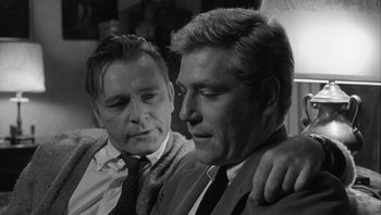 Movie still from “Who's Afraid of Virginia Woolf?” (1966), directed by Mike Nichols – Two men in business suits sitting next to each other; Close Up shot, Over the shoulder angle