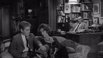 Movie still from “Who's Afraid of Virginia Woolf?” (1966), directed by Mike Nichols – A black and white photo of a man and a woman sitting on a couch in a living room; Medium shot, Over the shoulder angle