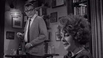 Movie still from “Who's Afraid of Virginia Woolf?” (1966), directed by Mike Nichols – An older man and a younger woman in a room; Medium shot, Over the shoulder angle