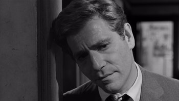 Movie still from “Who's Afraid of Virginia Woolf?” (1966), directed by Mike Nichols – Black and white photograph of a man in a suit and tie; Close Up shot, Low angle