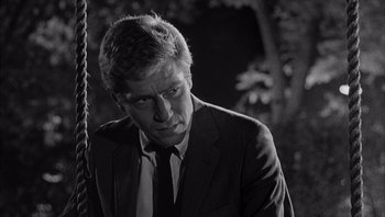 Movie still from “Who's Afraid of Virginia Woolf?” (1966), directed by Mike Nichols – Black and white photograph of a man wearing a suit and tie; Close Up shot, Low angle