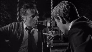 Movie still from “Who's Afraid of Virginia Woolf?” (1966), directed by Mike Nichols – Two men are talking and one of them is holding a drink; Close Up shot, Over the shoulder angle