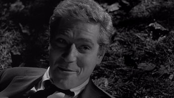 Movie still from “Who's Afraid of Virginia Woolf?” (1966), directed by Mike Nichols – Black and white photograph of a man in a suit and bow tie; Close Up shot, High angle