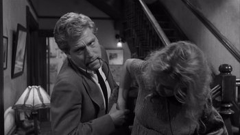 Movie still from “Who's Afraid of Virginia Woolf?” (1966), directed by Mike Nichols – A black and white photo of a man and a woman; Medium shot, Over the shoulder angle