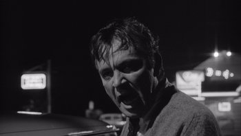 Movie still from “Who's Afraid of Virginia Woolf?” (1966), directed by Mike Nichols – A black and white photo of a man in a tie; Close Up shot, Low angle