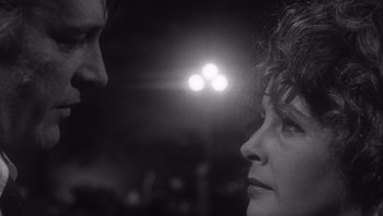 Movie still from “Who's Afraid of Virginia Woolf?” (1966), directed by Mike Nichols – A man and a woman face to face in a dimly - lit room; Close Up shot, Over the shoulder angle