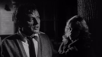 Movie still from “Who's Afraid of Virginia Woolf?” (1966), directed by Mike Nichols – A black and white photo of a man and a woman smoking; Close Up shot, Low angle