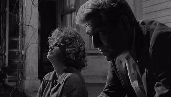 Movie still from “Who's Afraid of Virginia Woolf?” (1966), directed by Mike Nichols – A man and a woman sitting next to each other in a room; Close Up shot, Low angle