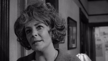 Movie still from “Who's Afraid of Virginia Woolf?” (1966), directed by Mike Nichols – An older woman is looking into the distance; Close Up shot, Over the shoulder angle