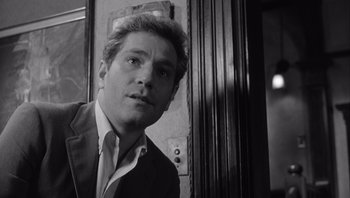 Movie still from “Who's Afraid of Virginia Woolf?” (1966), directed by Mike Nichols – Black and white photograph of a man in a suit and tie; Close Up shot, Low angle