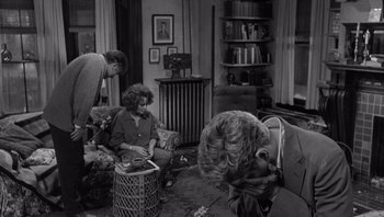 Movie still from “Who's Afraid of Virginia Woolf?” (1966), directed by Mike Nichols – A group of people sitting around a living room together; Medium shot, Over the shoulder angle