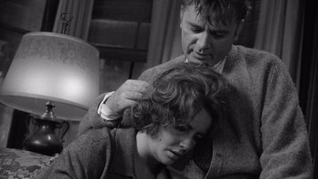 Movie still from “Who's Afraid of Virginia Woolf?” (1966), directed by Mike Nichols – An older man is combing a woman's hair; Medium shot, High angle