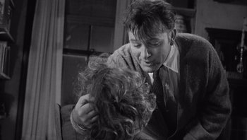 Movie still from “Who's Afraid of Virginia Woolf?” (1966), directed by Mike Nichols – A black and white photo of a man and a woman kissing; Close Up shot, Over the shoulder angle