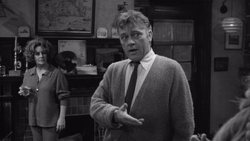 Movie still from “Who's Afraid of Virginia Woolf?” (1966), directed by Mike Nichols – An older man in a sweater and a tie; Medium shot, Over the shoulder angle